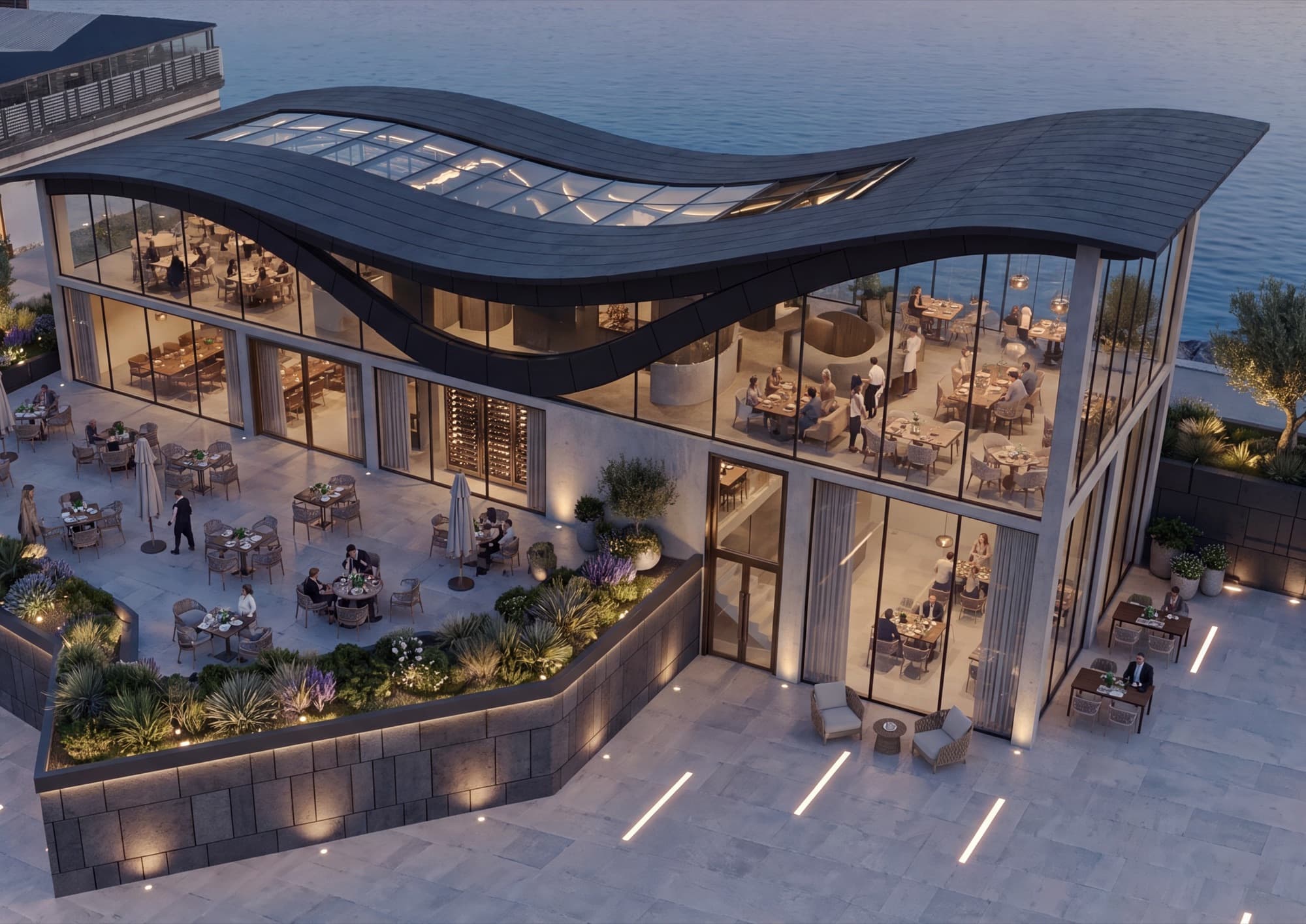 Aerial view of the undulating roof with skylights over the sea